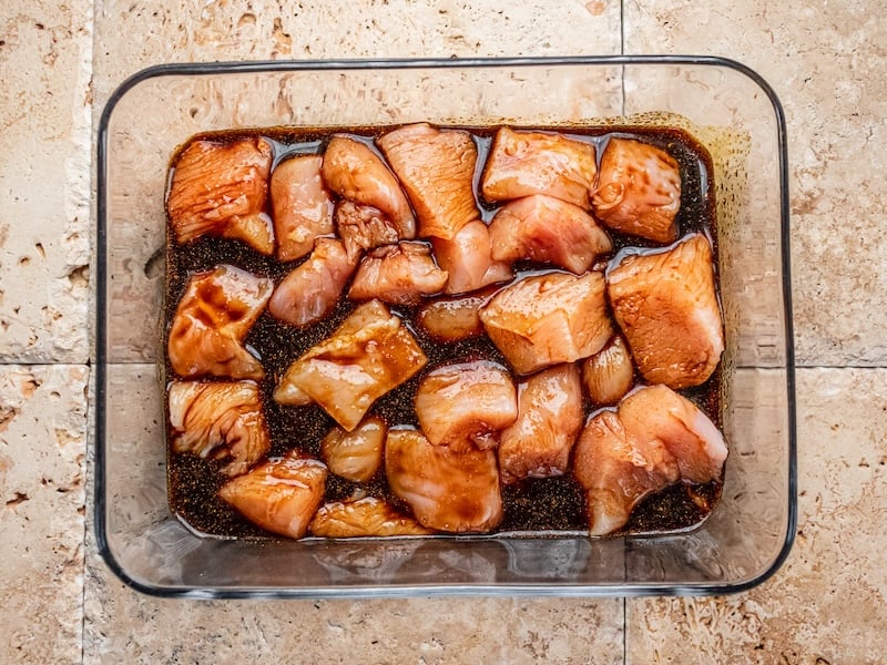Chunks of chicken marinating in a paleo-friendly blend made with coconut aminos, garlic, and Paleovalley Organic Spice Blends — easy, flavorful, and clean.