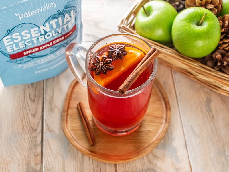 Elevated hot apple cider made with Paleovalley Essential Electrolytes Spiced Apple Cider, garnished with orange, cinnamon, and star anise.