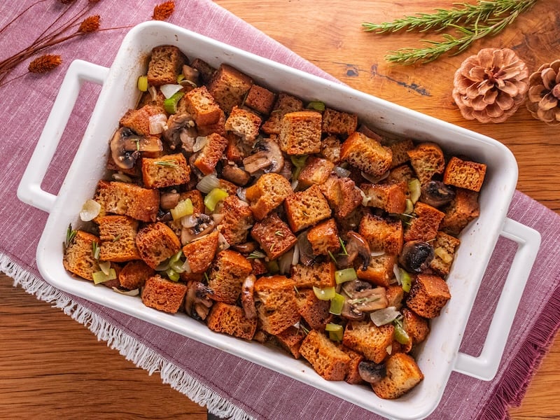Golden-brown homemade stuffing baked to perfection in a white ceramic dish using Paleovalley Bone Broth Protein for extra flavor and nutrition.