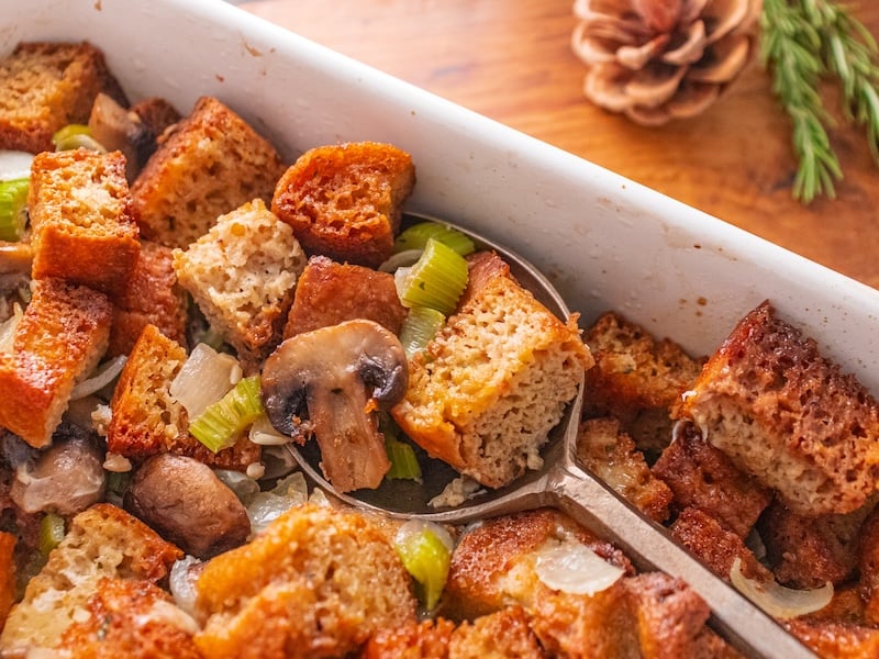 Golden-brown homemade stuffing baked to perfection in a white ceramic dish using Paleovalley Bone Broth Protein for extra flavor and nutrition.