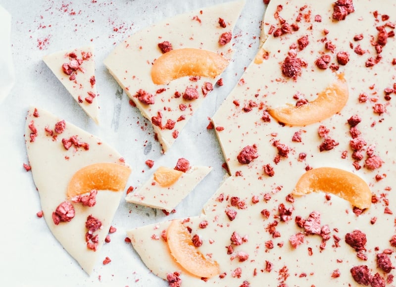 Collagen coconut bark topped with dried raspberries and apricot slices, made with Paleovalley bone broth protein.